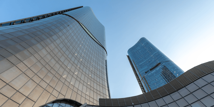 Three high rise buildings with glass windows.
